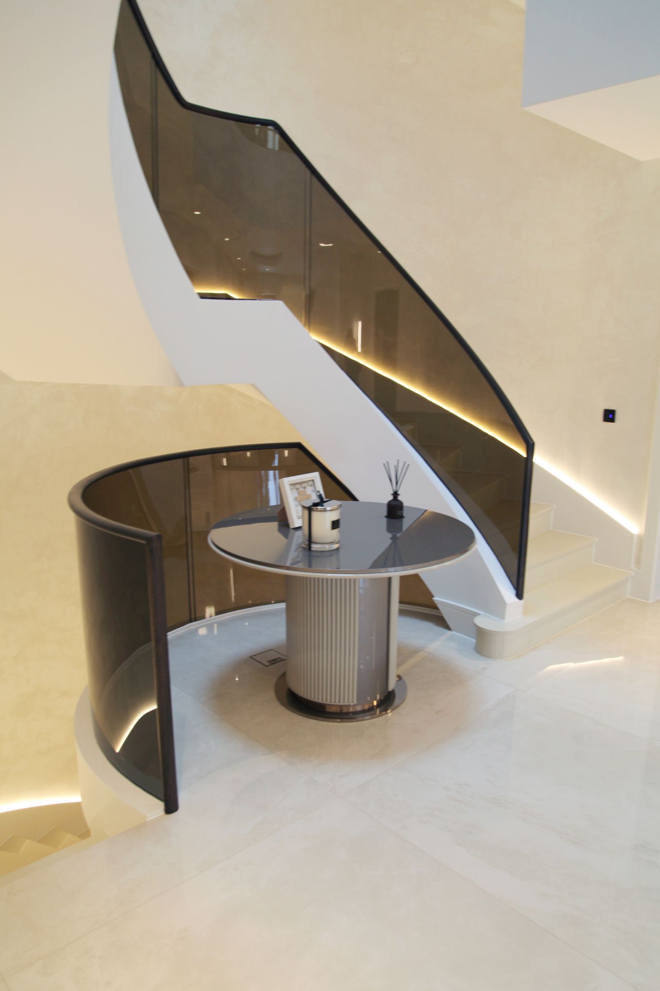 Bespoke Helical/Spiral staircase with curved Glass balustrade