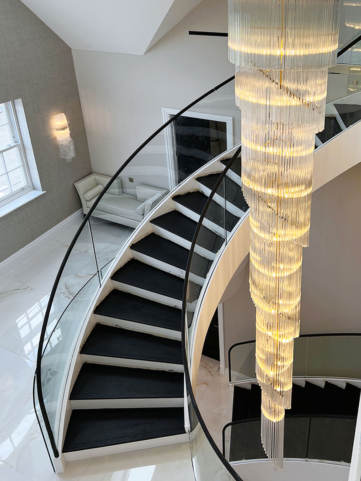 Bespoke Helical/Spiral staircase with curved Glass balustrade