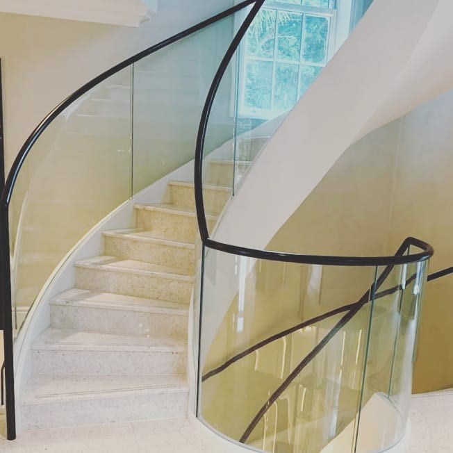 Bespoke Helical/Spiral staircase with curved Glass balustrade