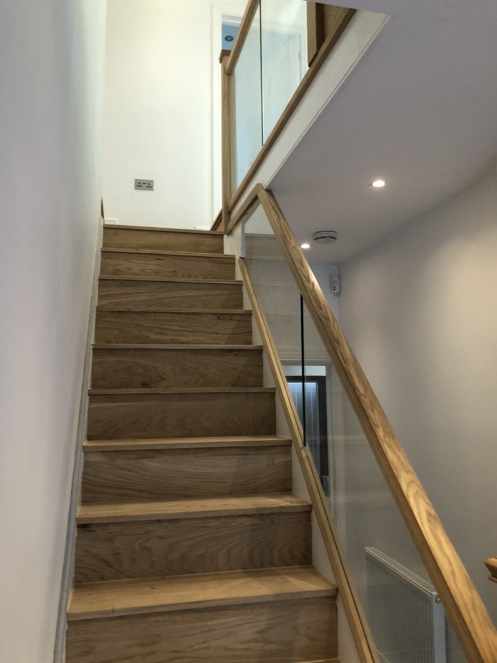 Wooden staircase with glass balustrade