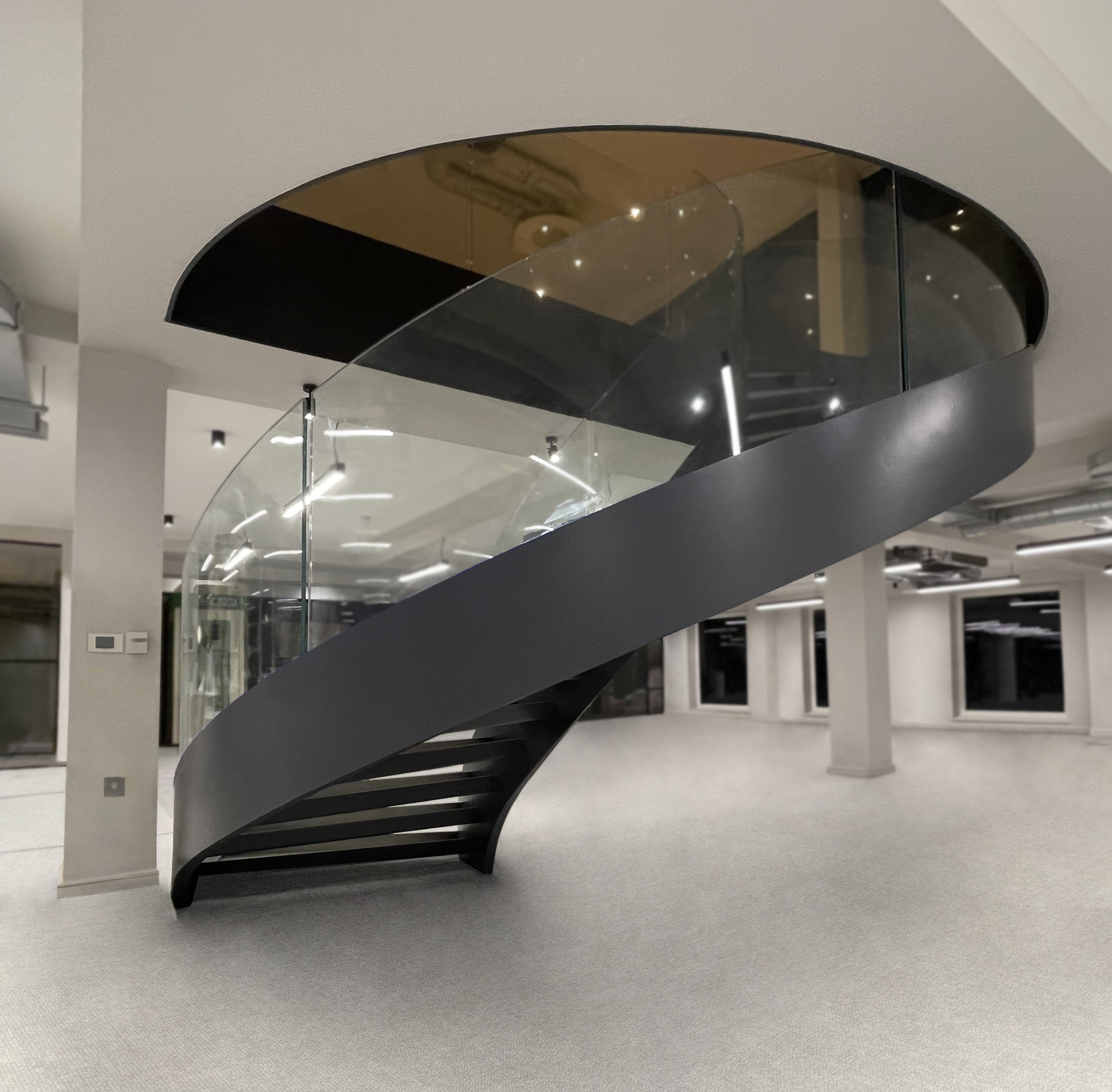 helical staircase with curved glass balustrade