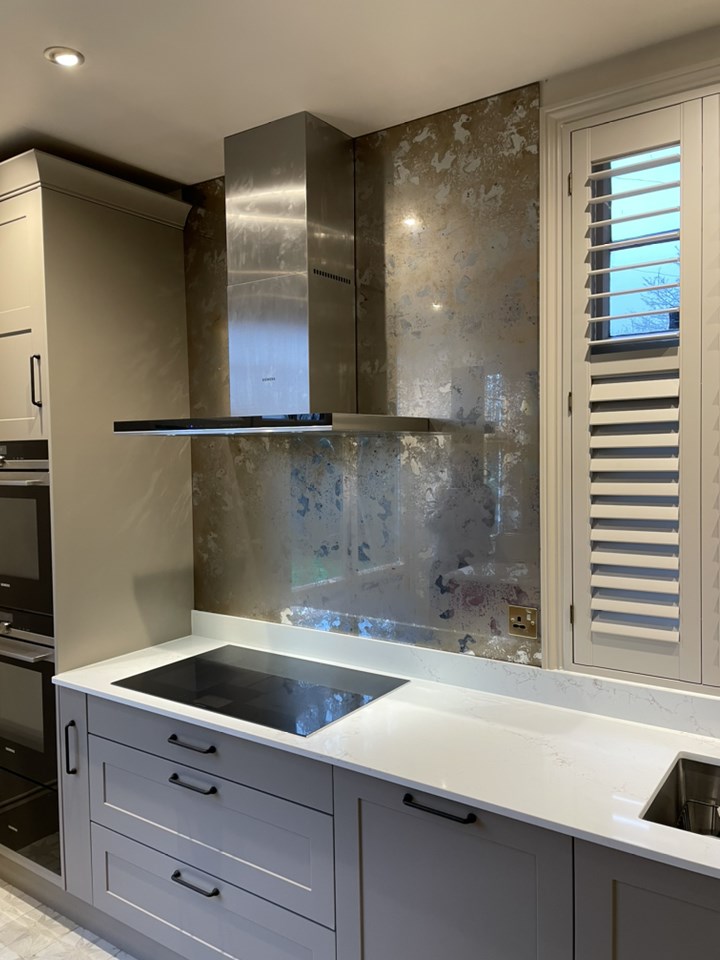 Custom designed mirror behind the electric stove