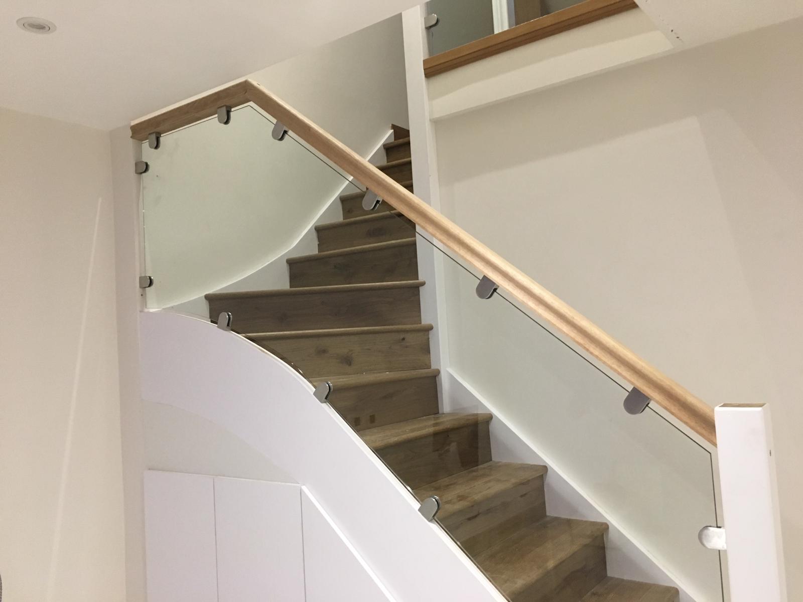Glass balustrades with wooden handrail