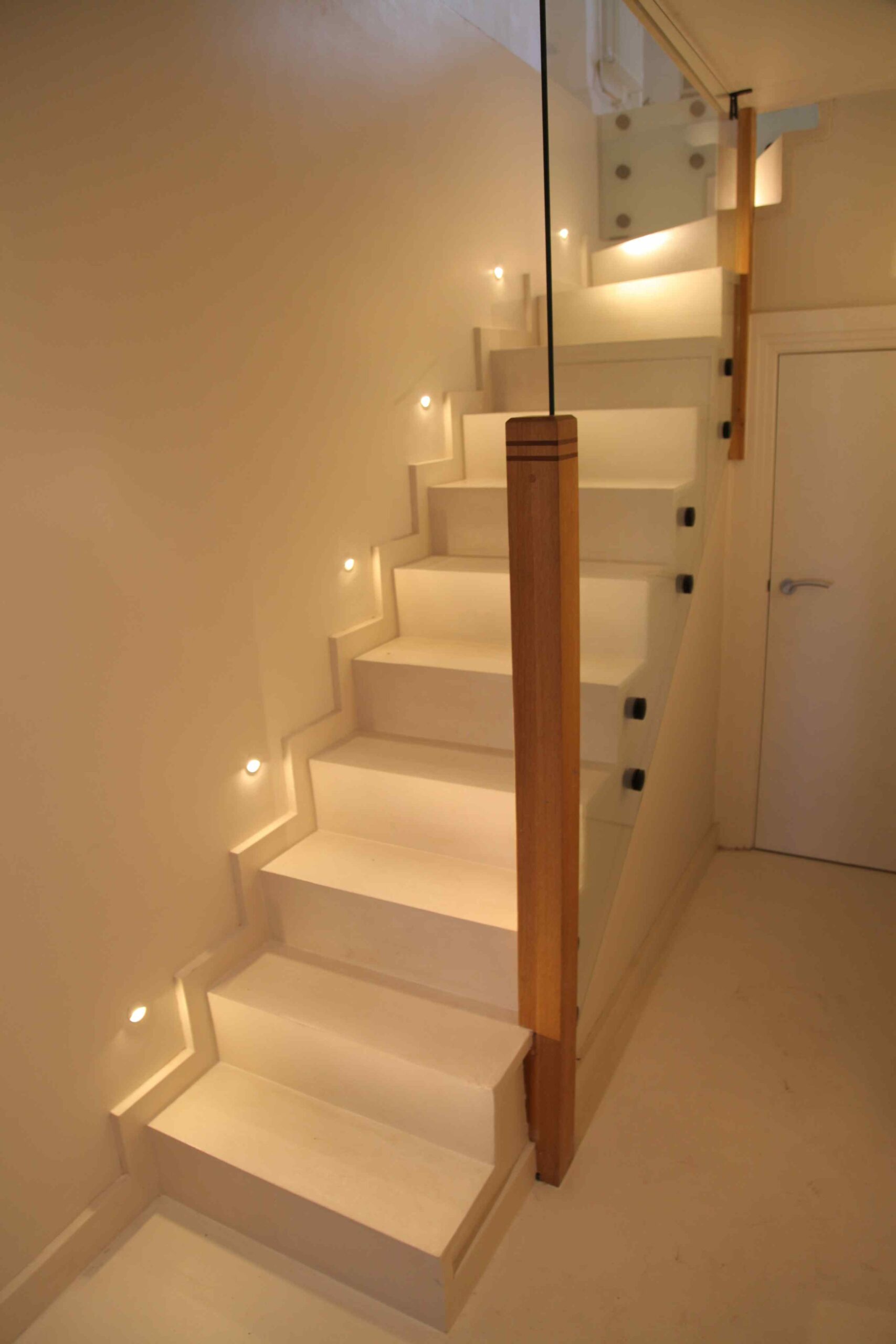 White staircase with a glass balustrade