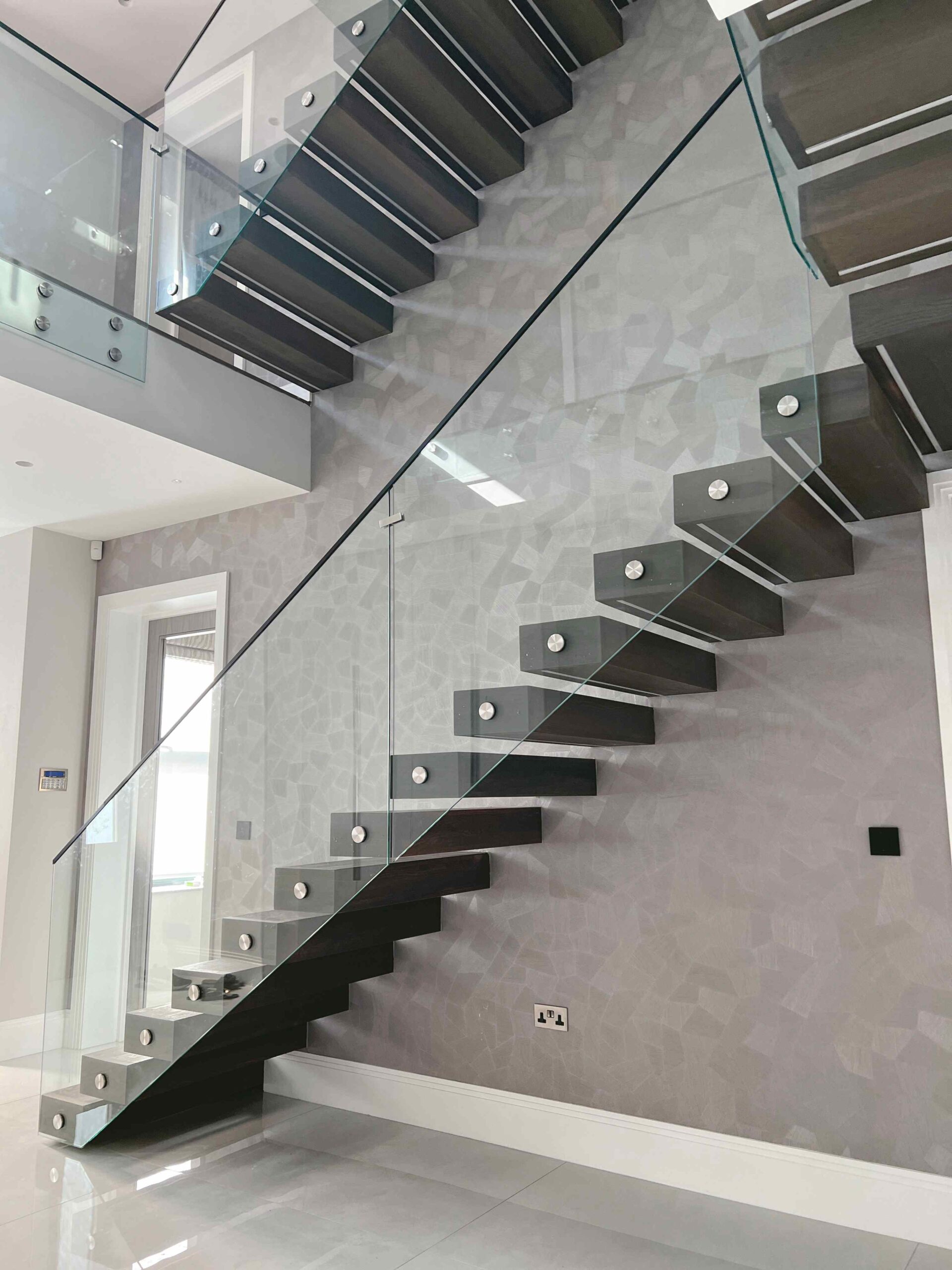 side view of a Floating staircase with glass balustrade
