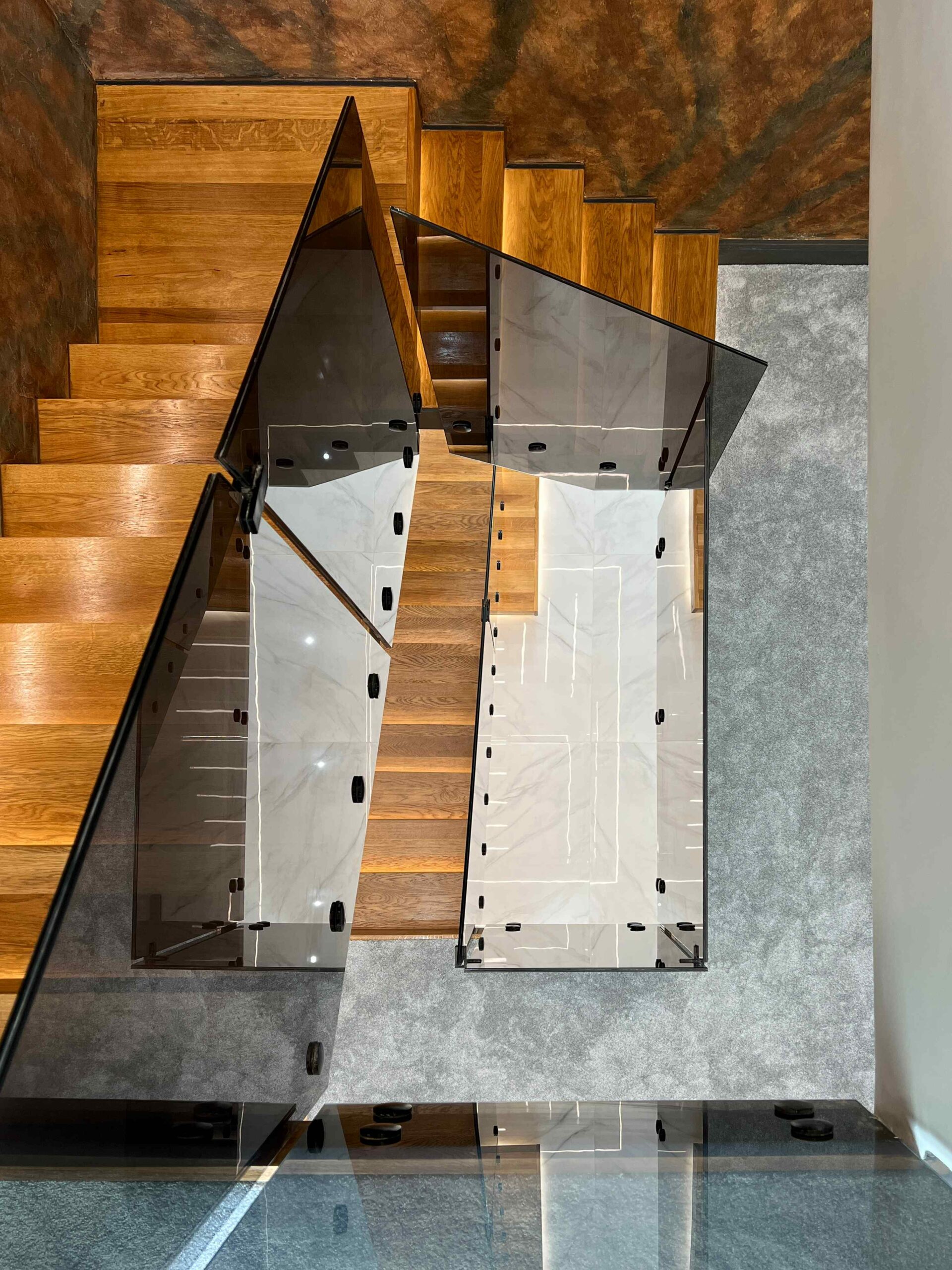 Top view of staircase with tinted glass balustrade