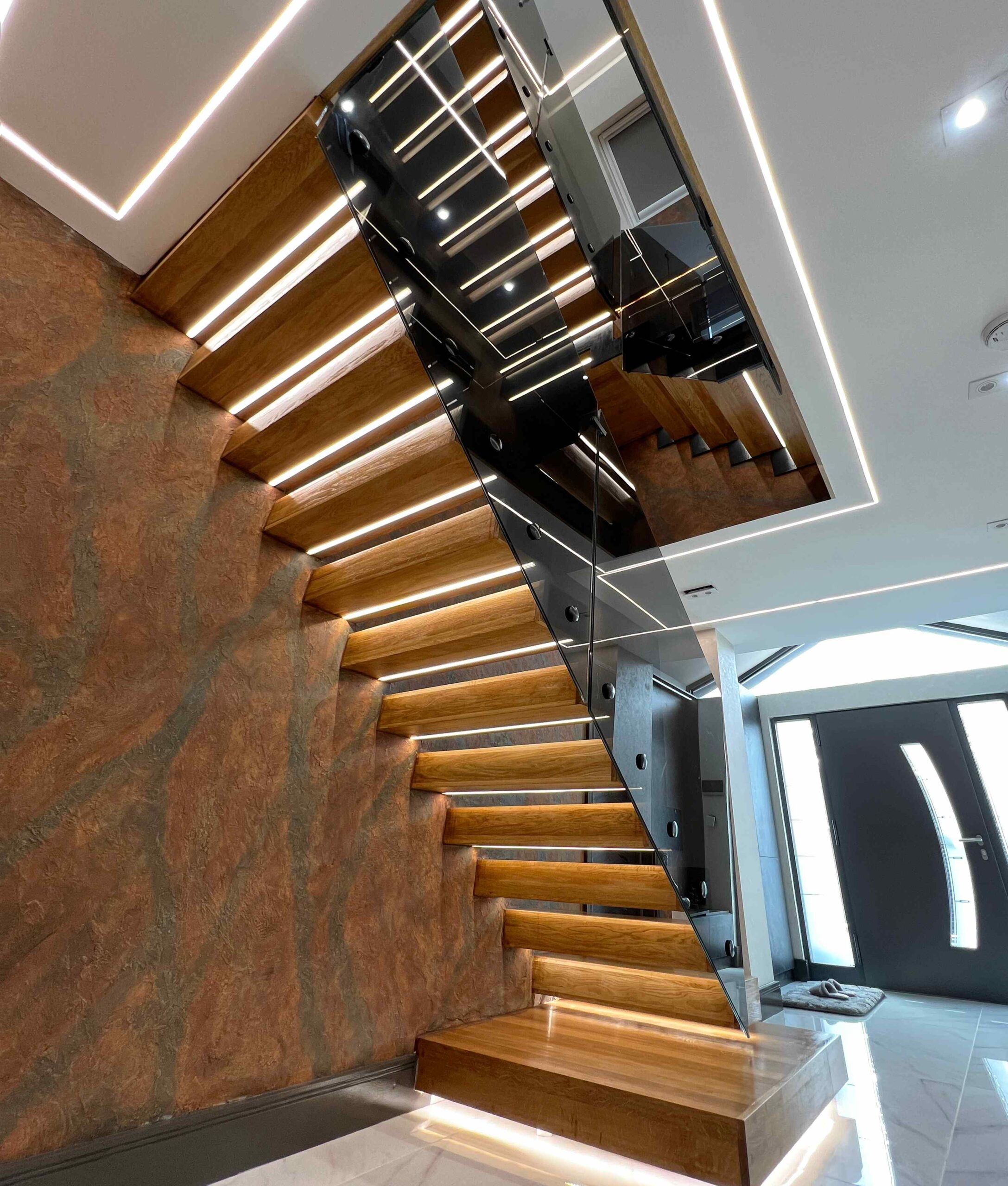 Bottom view of floating staircase with glass balustrade
