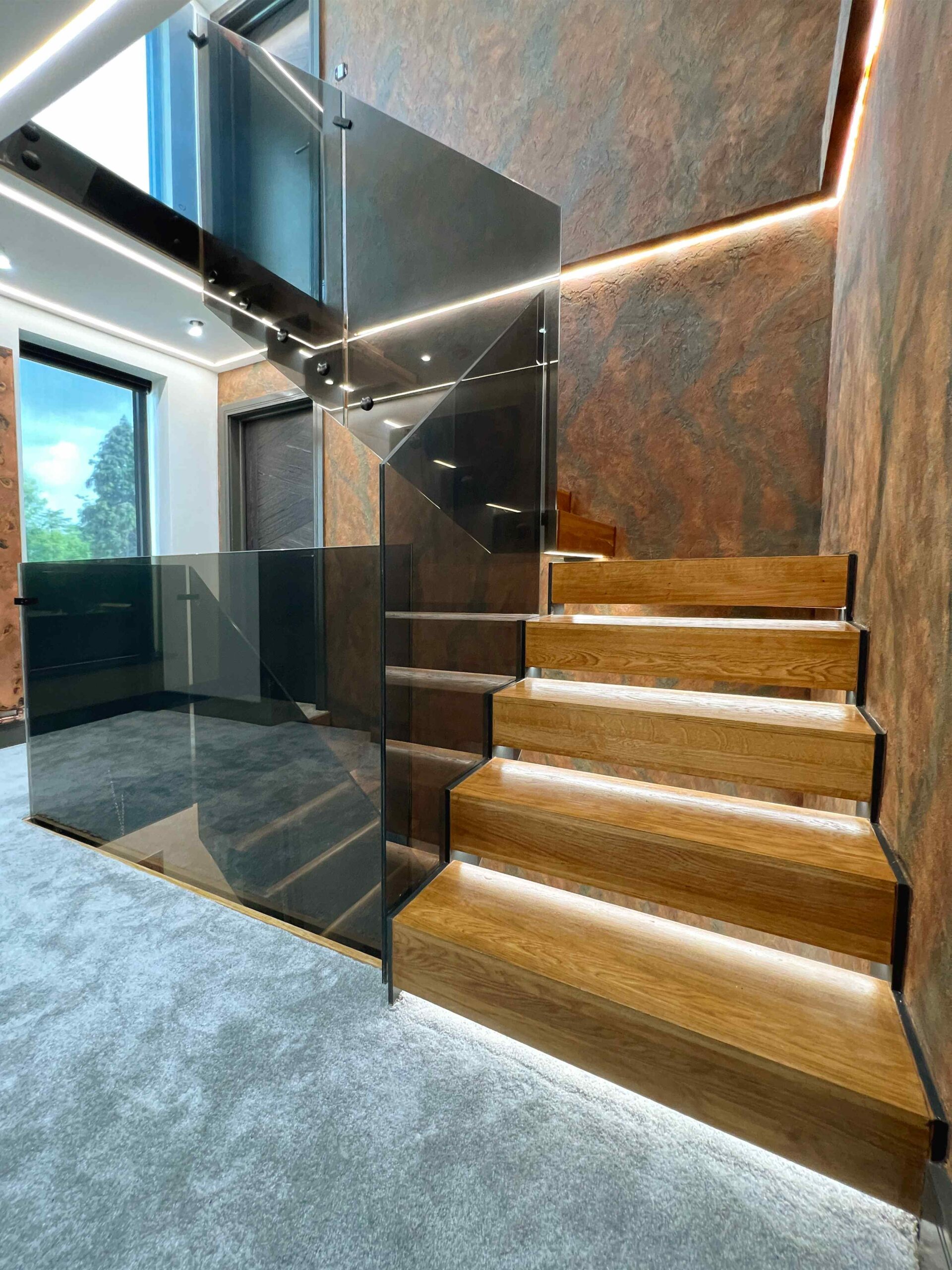 modern staircase with tinted glass balustrade